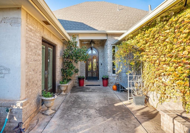 view of exterior entry featuring a patio area and french doors