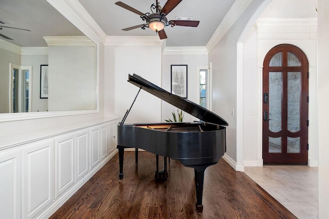 interior space with hardwood / wood-style flooring, ceiling fan, and ornamental molding