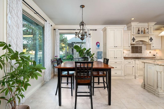 dining area featuring light tile patterned flooring and a chandelier