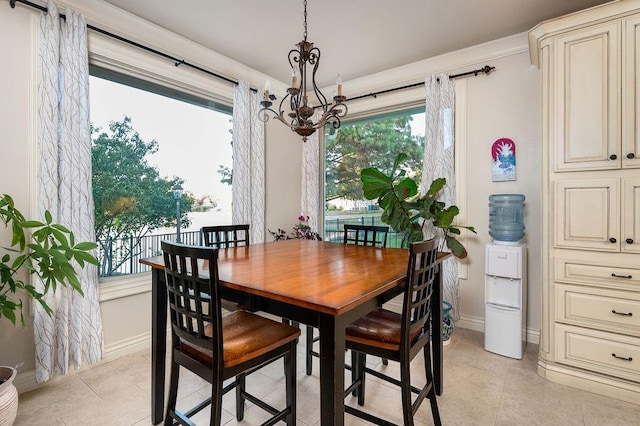 tiled dining space with a chandelier and a wealth of natural light