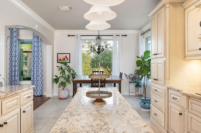 dining area with an inviting chandelier, light hardwood / wood-style flooring, and ornamental molding