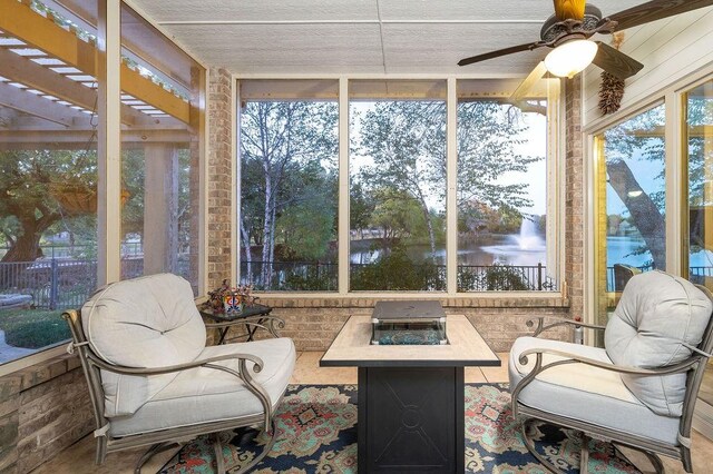 sunroom / solarium with ceiling fan and a healthy amount of sunlight