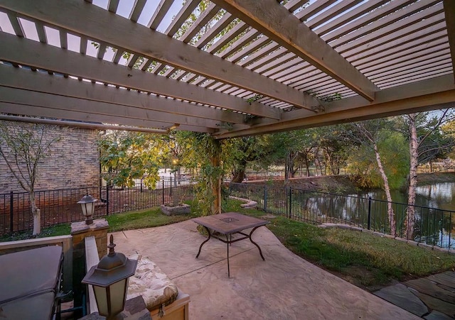 view of patio / terrace with a pergola and a water view