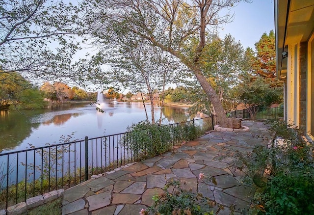 view of patio with a water view