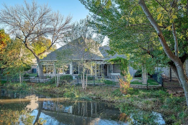 back of property with a water view