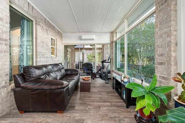 sunroom / solarium with an AC wall unit and plenty of natural light