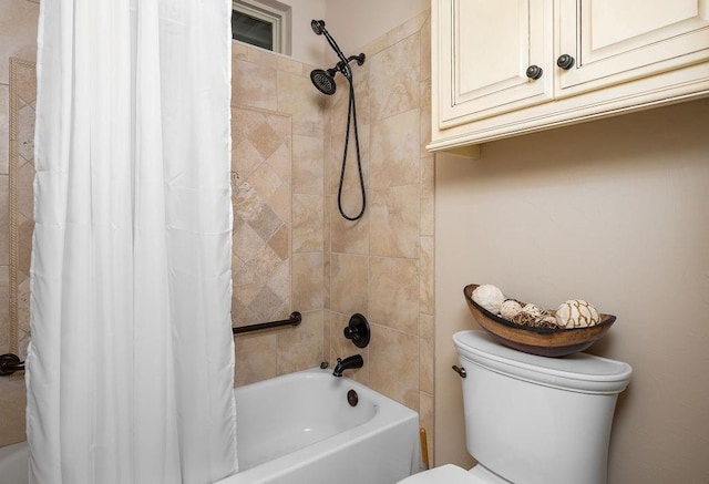 bathroom featuring shower / tub combo and toilet