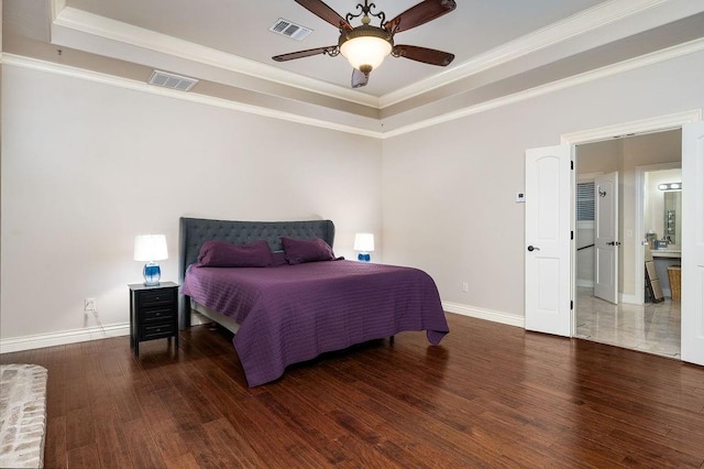 bedroom with ceiling fan, dark hardwood / wood-style floors, a raised ceiling, and crown molding