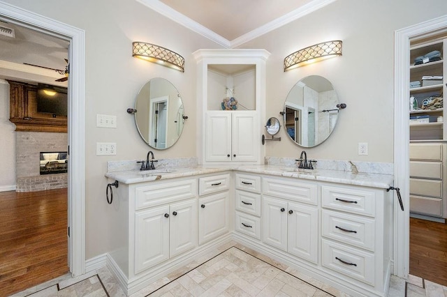 bathroom with crown molding, hardwood / wood-style floors, vanity, and ceiling fan