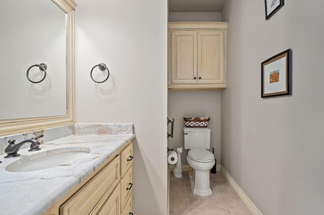 bathroom featuring tile patterned flooring, vanity, and toilet