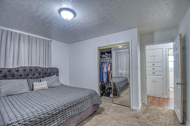 bedroom with carpet floors, a textured ceiling, and a closet