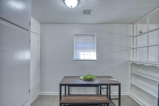 dining area featuring a textured ceiling