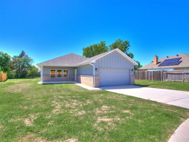 ranch-style house featuring a garage and a front lawn