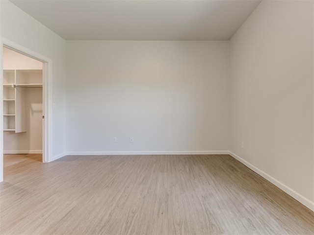 empty room with light hardwood / wood-style flooring