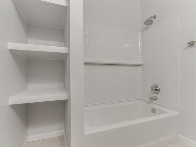 bathroom featuring tile patterned flooring and tiled shower / bath