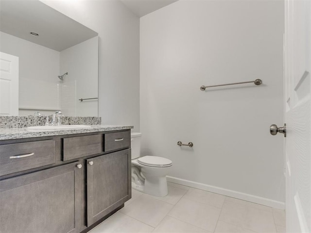 bathroom with toilet, vanity, tile patterned floors, and walk in shower