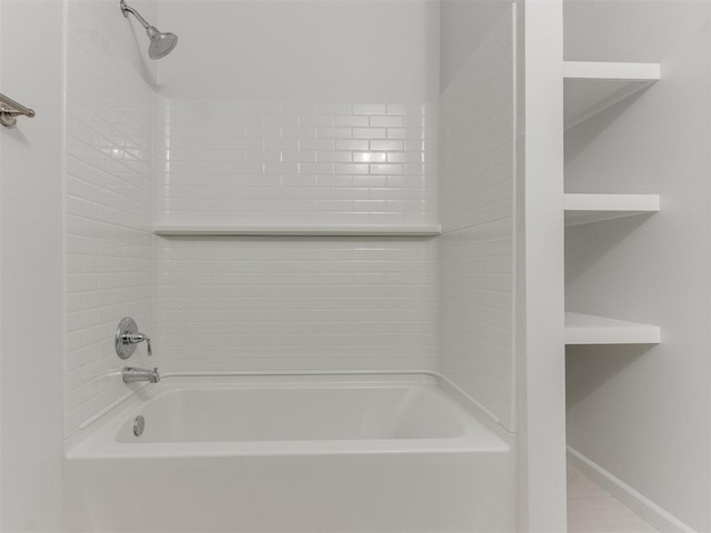 bathroom with tile patterned floors and tiled shower / bath