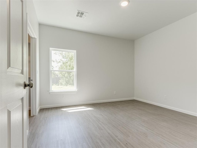 unfurnished room with light hardwood / wood-style flooring