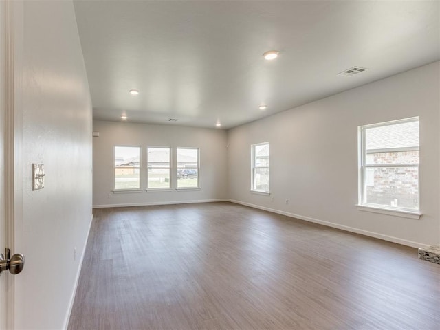 empty room featuring wood-type flooring and a wealth of natural light