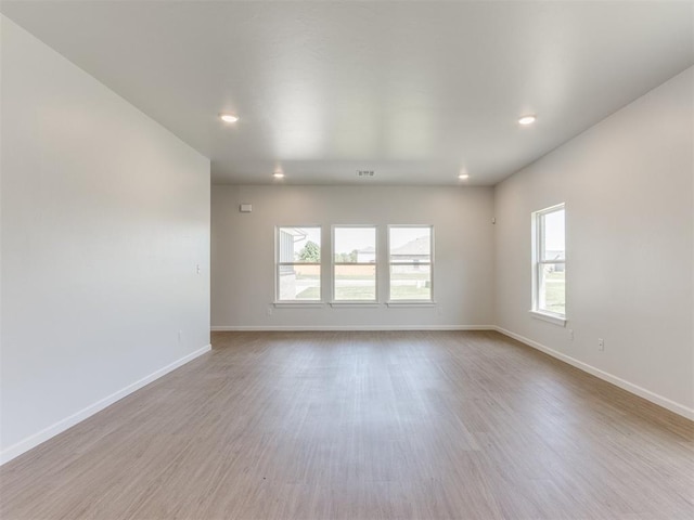 spare room with light wood-type flooring