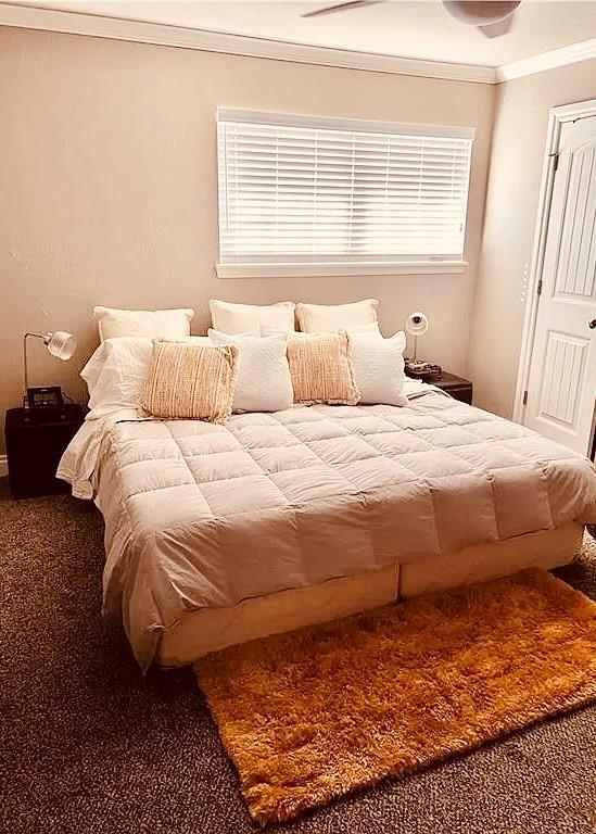 carpeted bedroom with crown molding