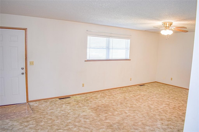 carpeted empty room featuring a textured ceiling and ceiling fan