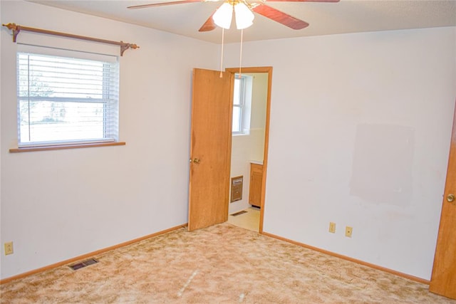 carpeted empty room with ceiling fan