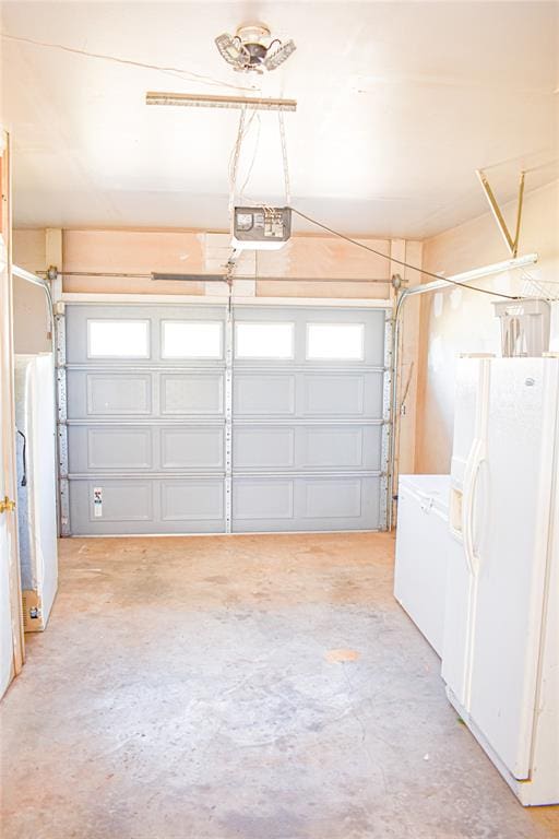 garage with white fridge, white fridge with ice dispenser, and a garage door opener