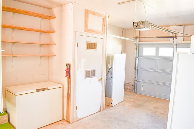 garage with white fridge and a garage door opener