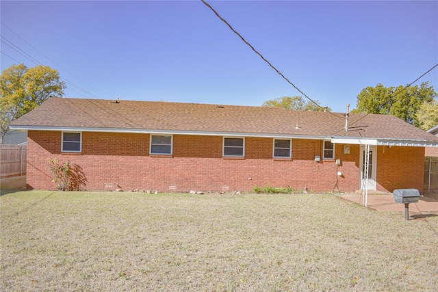 rear view of house featuring a lawn and a patio area