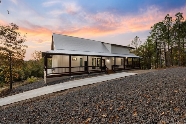 back house at dusk with covered porch