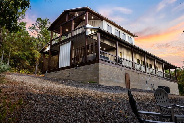 property exterior at dusk featuring central AC