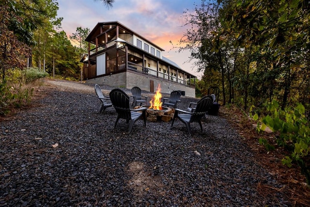 exterior space featuring a fire pit and a sunroom