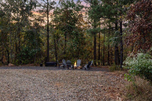 yard at dusk with an outdoor fire pit