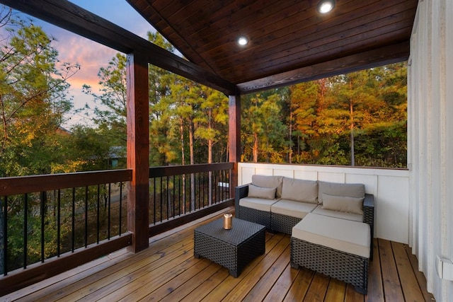 deck at dusk with an outdoor living space