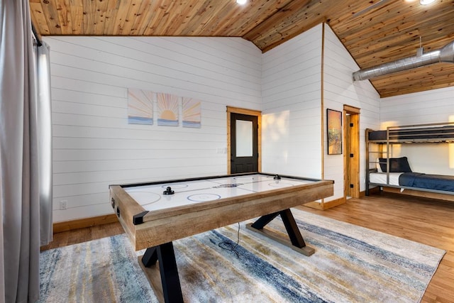 playroom featuring light hardwood / wood-style floors, wooden ceiling, and wood walls