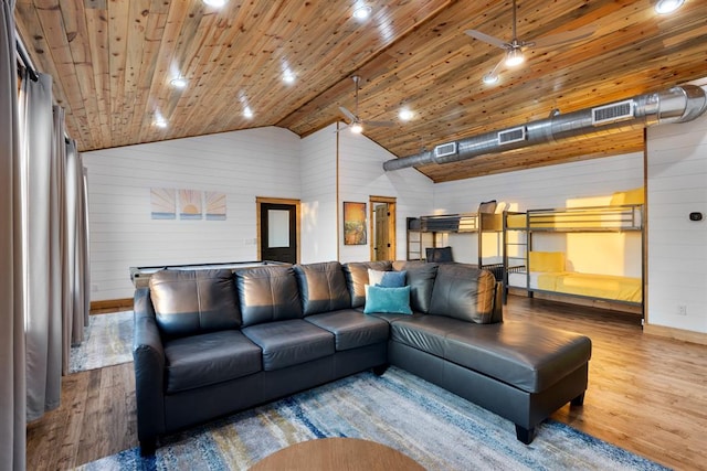 living room featuring wooden walls, wood ceiling, hardwood / wood-style floors, high vaulted ceiling, and ceiling fan