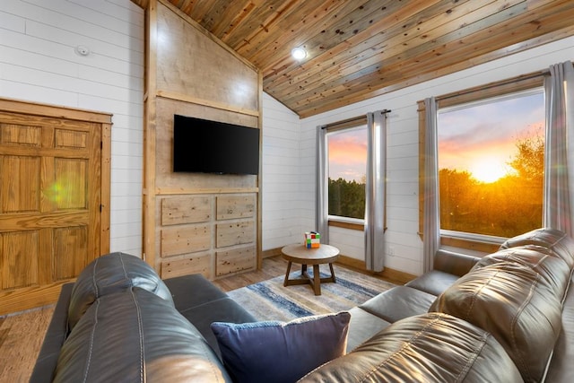 living room with light wood-type flooring, wood walls, vaulted ceiling, and wood ceiling