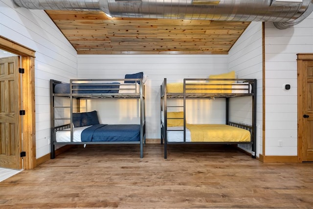 unfurnished bedroom featuring wooden ceiling, lofted ceiling, and wood-type flooring