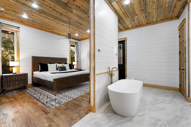 bedroom featuring wood walls, wooden ceiling, and multiple windows