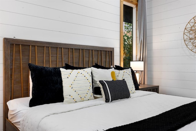 bedroom with wooden walls