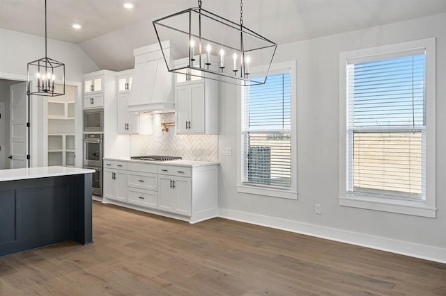 kitchen featuring stainless steel appliances, white cabinets, dark wood-type flooring, and decorative light fixtures