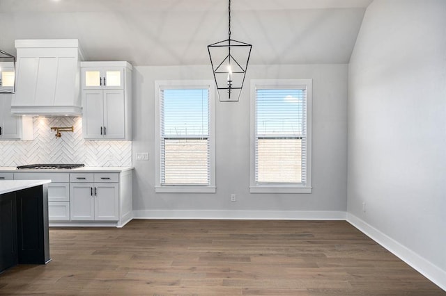 kitchen with white cabinets, dark hardwood / wood-style floors, and pendant lighting