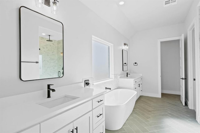 bathroom featuring plus walk in shower, vanity, lofted ceiling, and tile patterned flooring