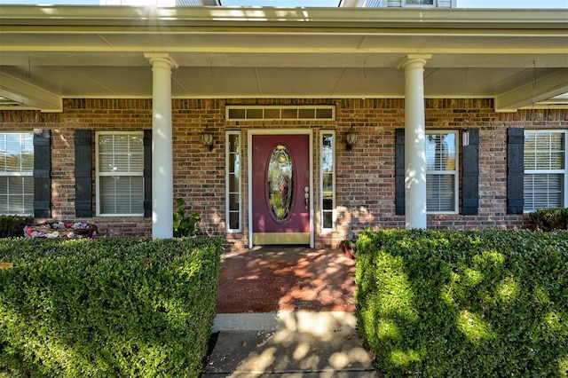 view of exterior entry featuring a porch