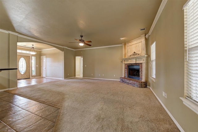 unfurnished living room featuring carpet floors, crown molding, a fireplace, and ceiling fan