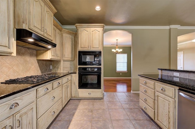 kitchen with black appliances, light tile patterned flooring, dark stone countertops, and crown molding