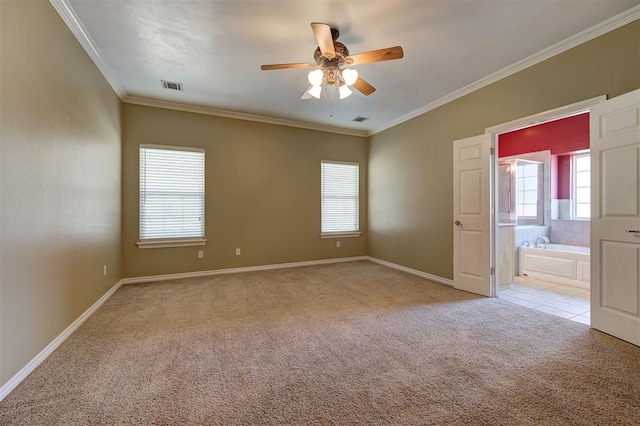 carpeted empty room featuring ceiling fan and crown molding