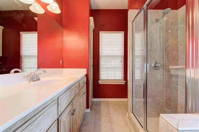 bathroom featuring tile patterned floors, plenty of natural light, and a shower with shower door