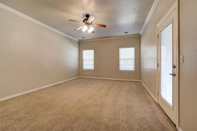 carpeted empty room with ceiling fan and ornamental molding